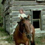 The first ride on a horse at Grandpa and Grandma's home.