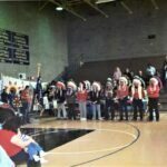 The Pall Bearers standing in prayers at Chief Fools Crow's funeral ceremony held at the gym of the Kyle School.