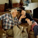 Chief Fools Crow telling Grandma Kate Pony Leggins Fools Crow, a story at their home.