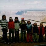 The kids lined up at the Grand Canyon.