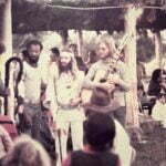 We, Artists Paul Collins, Larry Thompson, Dik, John Denver & musician Dean Evanson listening to Chief Fools Crow praying . Paul painted Grandpa that's in a series entitled "Other Vocies"