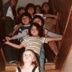 Children on the stairway anxiously waitingto see what's under the Solstice Tree.